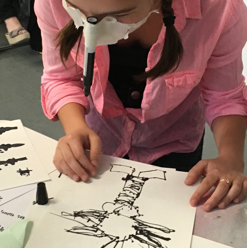 A student is exploring using more of her 13 senses to develop her perceptual awareness through drawing with no hands. 